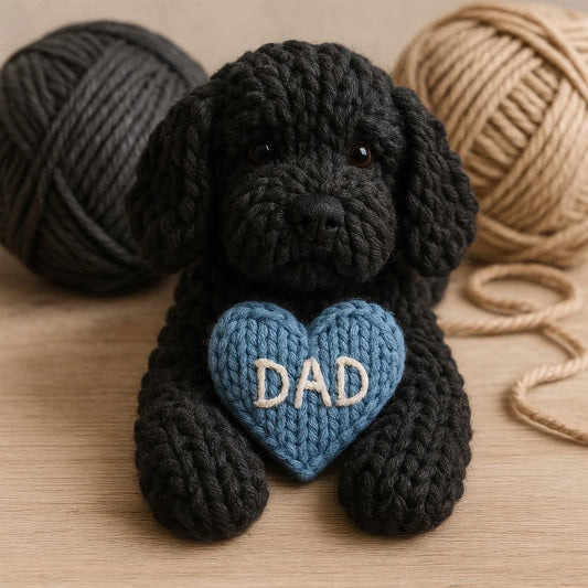 Knitted black cockapoo with a blue heart that says DAD